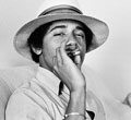 Obama smoking a cigarette wearing his "pimp" hat